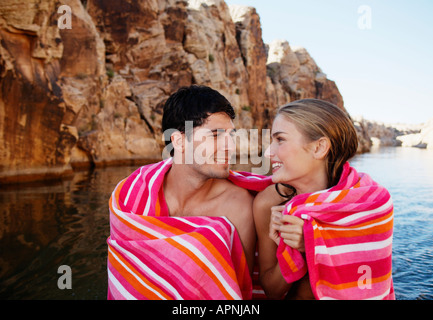 Young couple wrapped in a towel and looking at each other Stock Photo
