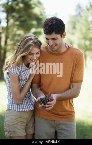 Young couple holding pine cones Stock Photo