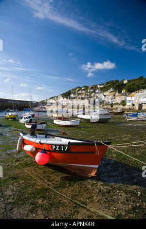 Mousehole Harbour at low tide showing boats and cottages, West Cornwall Stock Photo