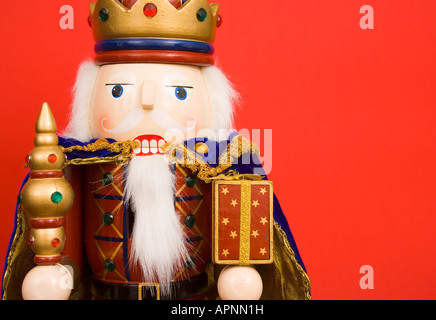 A traditional Christmas nutcracker ornament isolated on red Stock Photo