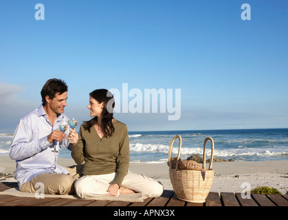 Couple drinking wine on beach, Cape Town, South Africa Stock Photo