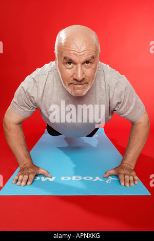 Senior man doing push ups Stock Photo