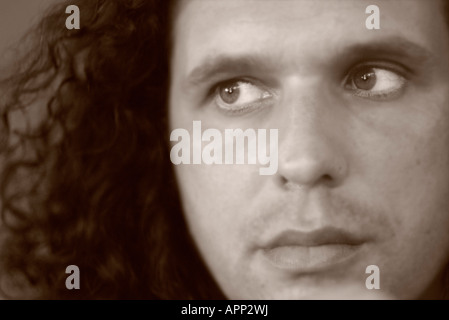 Blurred close-up portrait of man in brown toned black and white Stock Photo