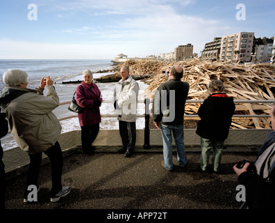 Tourists posing in front of the washed up wood from the sunken Ice Prince Worthing Pier West Sussex England UK Stock Photo