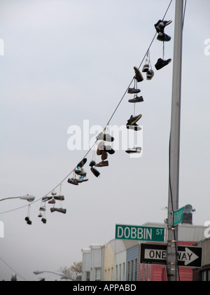 Shoes hanging on electric line Brooklyn New York Stock Photo