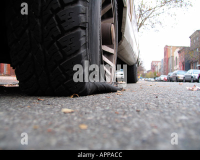 Deflated tire on street (close up), New York City, New York, USA Stock Photo