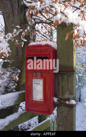 Post Box in the Snow mounted on a post Stock Photo