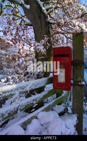 Post Box in the Snow mounted on a post Stock Photo