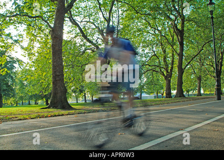 Cycling on Broad Walk in Hyde Park, London Stock Photo