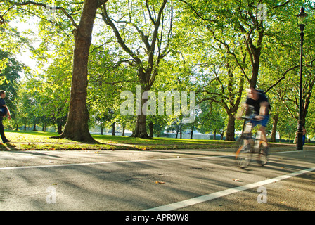 Cycling on Broad Walk in Hyde Park, London Stock Photo