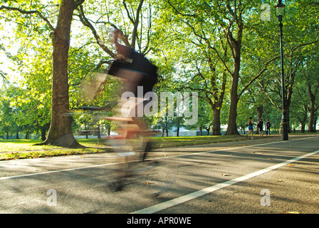 Cycling on Broad Walk in Hyde Park, London Stock Photo