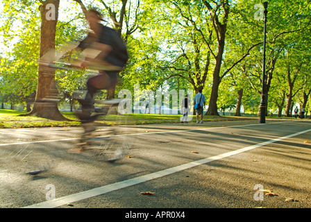 Cycling on Broad Walk in Hyde Park, London Stock Photo