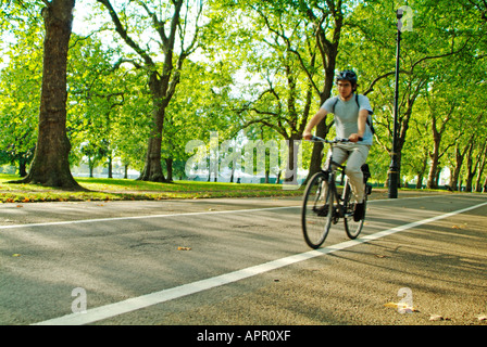 Cycling on Broad Walk in Hyde Park, London Stock Photo