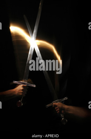 A clash of swords in the darkness. Stock Photo