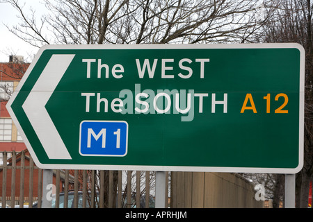 traffic sign on the westlink in central Belfast showing directions to the west the south via A12 M1 motorway Northern Ireland Stock Photo