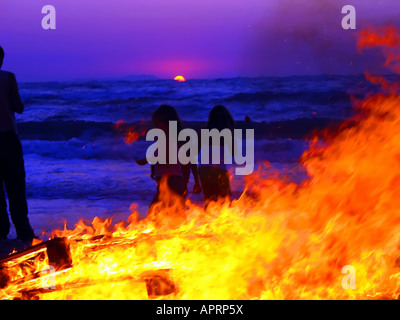 fire sunset party on the beach Stock Photo