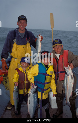 set net fishing for Kenai River sockeye salmon with Karl Kircher and sons holding up their catch in Cook Inlet Alaska Stock Photo