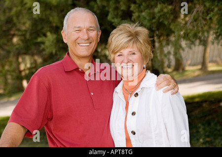 husband and wife posing on golf course Stock Photo