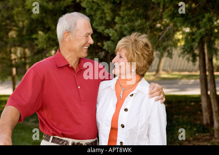 husband and wife posing on golf course Stock Photo