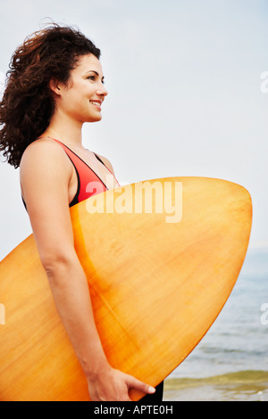 Young woman holding boogie board Stock Photo
