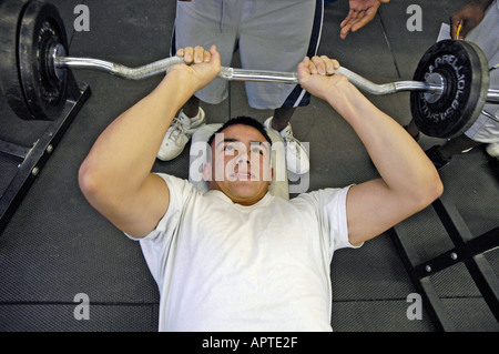 High school student lifts iron weights in a body building class Stock Photo