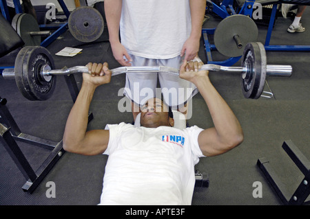 High school student lifts iron weights in a body building class Stock Photo