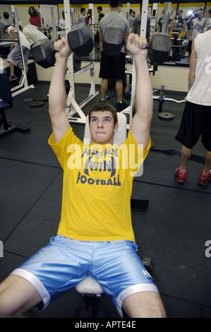 High school student lifts iron weights in a body building class Stock Photo