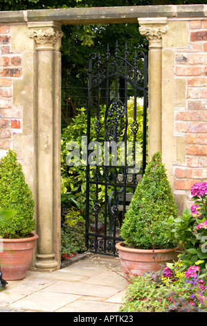 Flower Show Traditional Victorian style townhouse garden with arched gate and box topiary Stock Photo