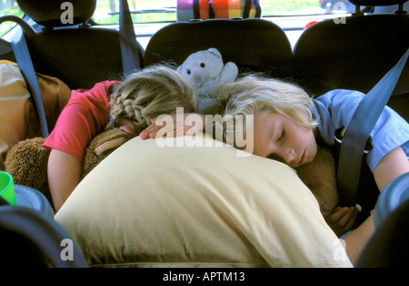 Two girls sleeping in the car Stock Photo