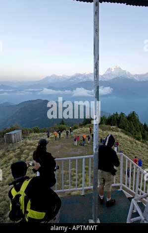 Trekker watching the Dhaulagiri range from a tower view. Poon Hill. Ghorepani village. Annapurna circuit trek. Nepal Stock Photo