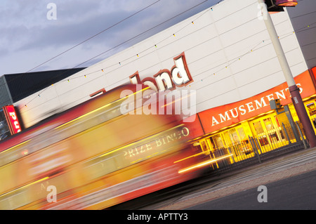 Tram passing Funland amusement arcade on Blackpool Promenade Stock Photo
