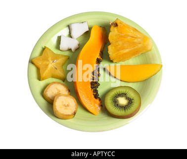 Fresh cut tropical fruit on green plate. Stock Photo