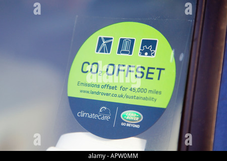 C02 Offset sticker on the windscreen of a Land Rover Defender. UK. Stock Photo