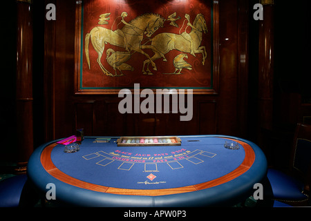 Close up of a Blackjack table winning playing cards with gambling chips casino roulette wheel gaming house gambling plaything Stock Photo