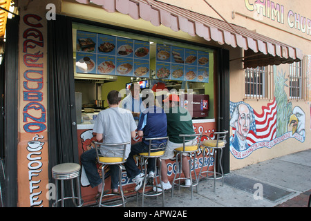 Miami Florida,Little Havana,Calle Ocho,Hispanic Latinos man men male,coffee shop small business,dining Cuban food stools sidewalk café restaurant Stock Photo