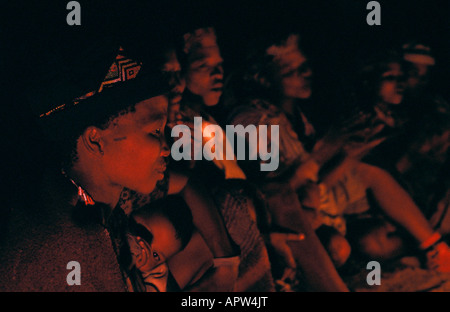 Bushwomen sitting at fire and singing Namibia Stock Photo