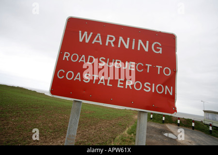 Sign warning of Road Collapse due to Coastal Erosion on Yorkshire Coast Between Hornsea and Bridlington Stock Photo