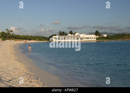 Beachside pavillion on the Caribbean island of Anguilla with people walking on the Beach  Stock Photo