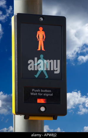 PEDESTRIAN CROSSING CONTROL BOX WITH ILLUMINATED RED MAN ICON AND BLUE SKY Stock Photo