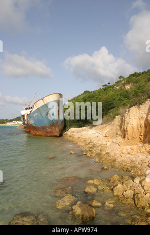 Rusting shipwreck stranded on the beach of Sandy Ground Bay on the Caribbean island of Anguilla Stock Photo