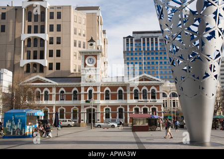 Old Post Office clock tower in 'cathedral square' city centre with The Chalice modern steel sculpture Christchurch New Zealand Stock Photo