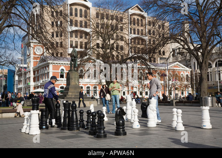 People playing with public giant floor chess set in "Cathedral Square" in city centre Christchurch New Zealand Stock Photo
