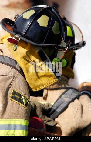 Two firefighters extinguishing a structure fire Stock Photo
