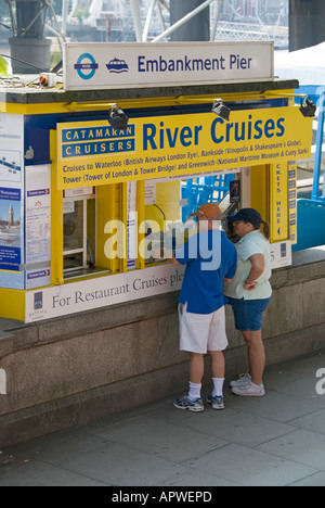 Ticket booth for river cruises located beside the Thames with two people being served Stock Photo