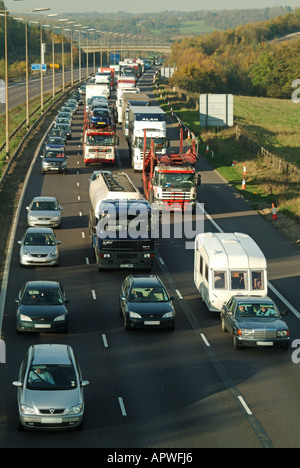 M25 motorway slow moving and stationary traffic queuing to pass accident on opposite closed carriageway Stock Photo