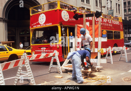 USA New York City Two Hard Hats Doing Street Repairs on Fifth Avenue NYC Stock Photo