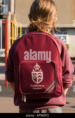 Primary schoolgirl wearing school logo backpack, London, UK. Stock Photo