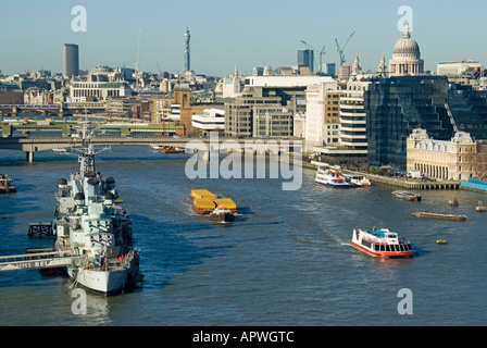 London semi aerial view River Thames HMS Belfast cruiser floating museum moored in pool of London City & West End skyline beyond Stock Photo