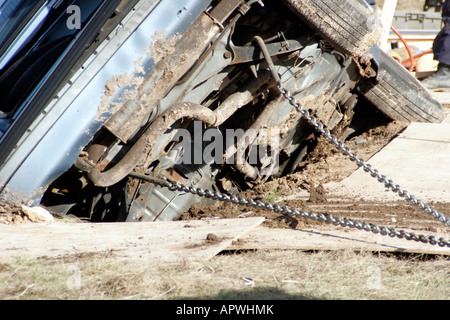 A car that had driven into an open trench has been anchored with chains and secured from moving Stock Photo