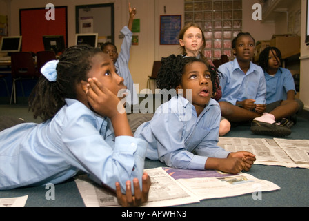 Primary school children attending newspaper group at after school club, Kennington, London, UK. Stock Photo